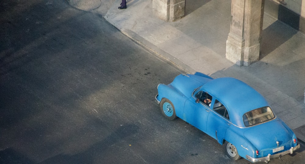 blue beetle car parked on gray concrete floor