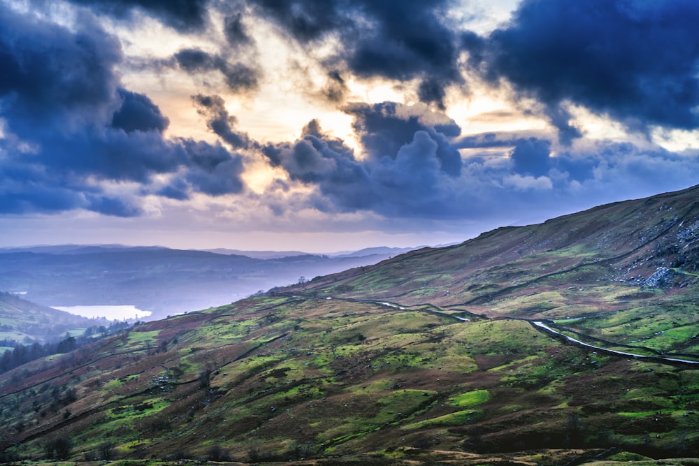 green mountain under white clouds during daytime