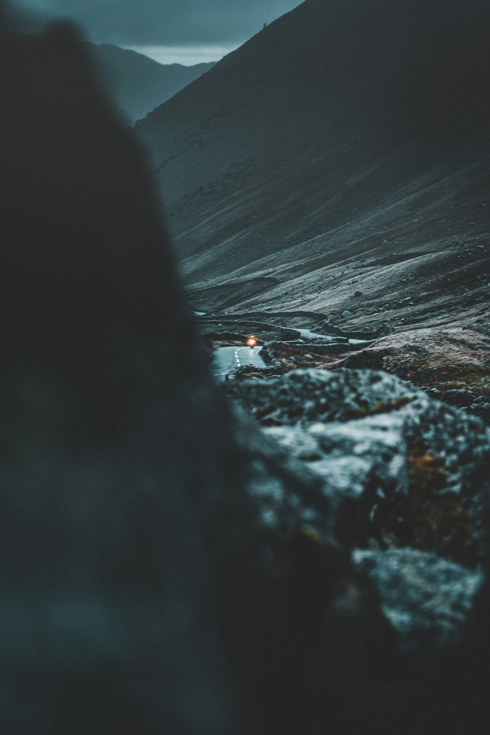 person in red jacket walking on gray rock formation during daytime