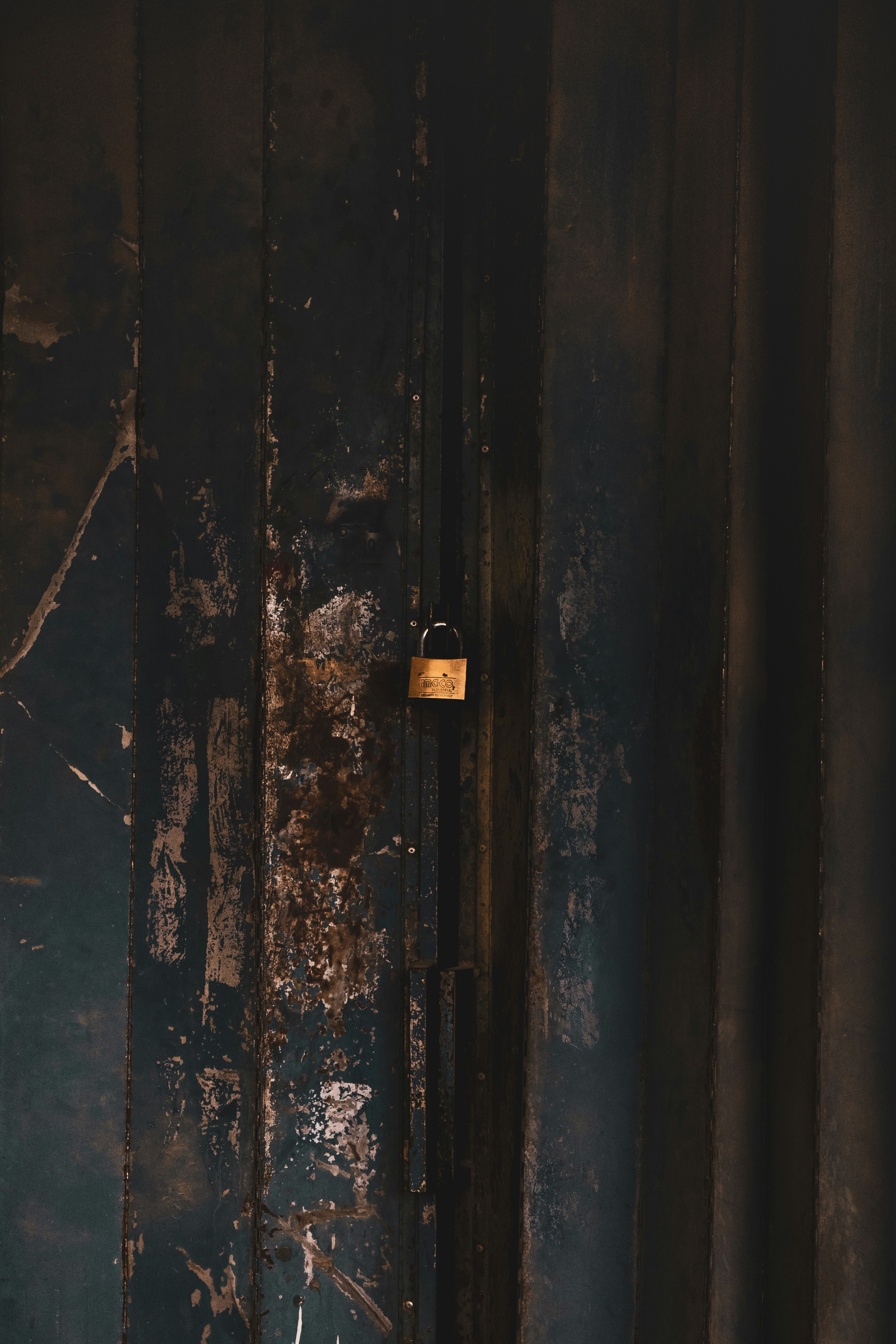black and brown padlock on black metal door