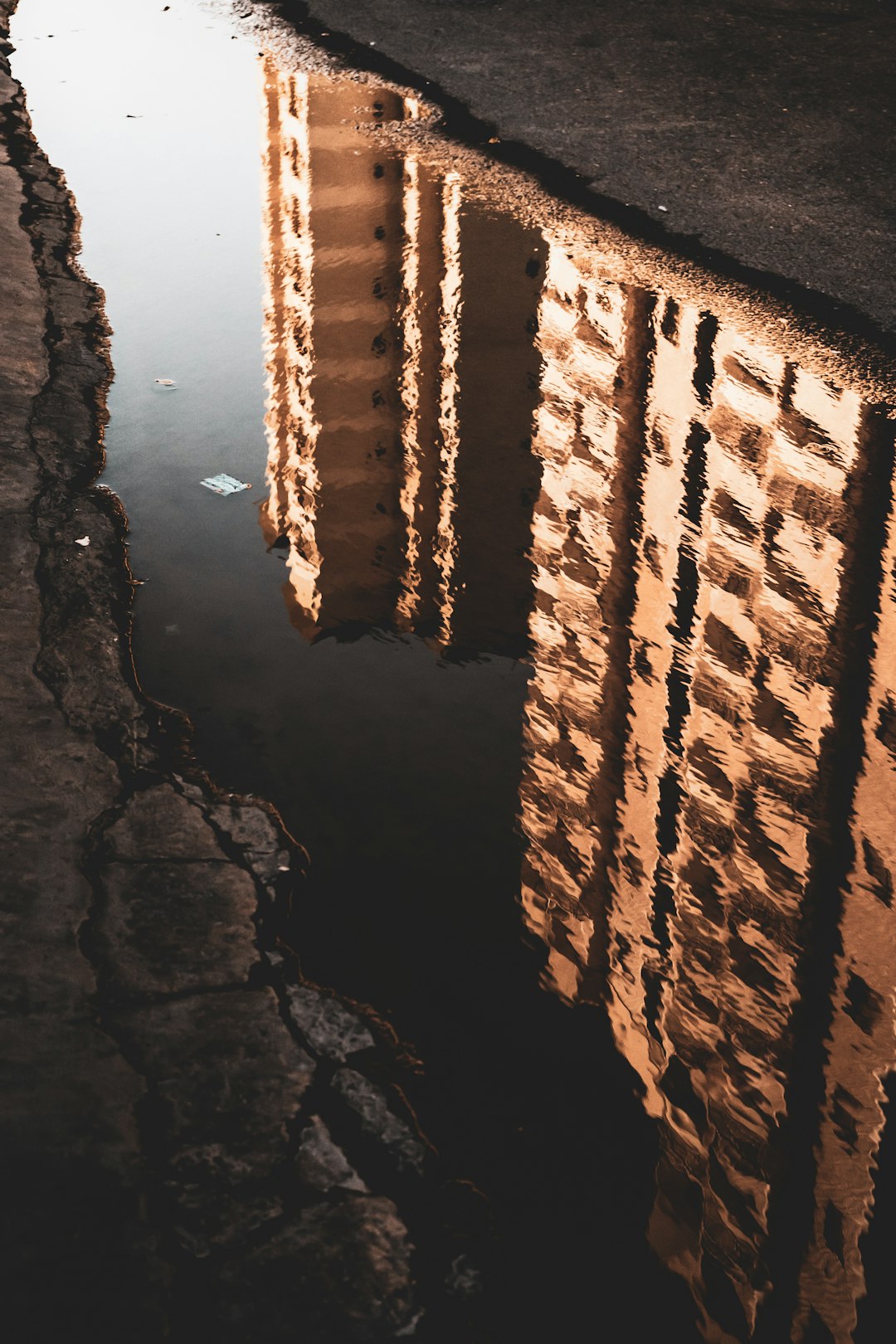 brown brick wall near body of water during daytime