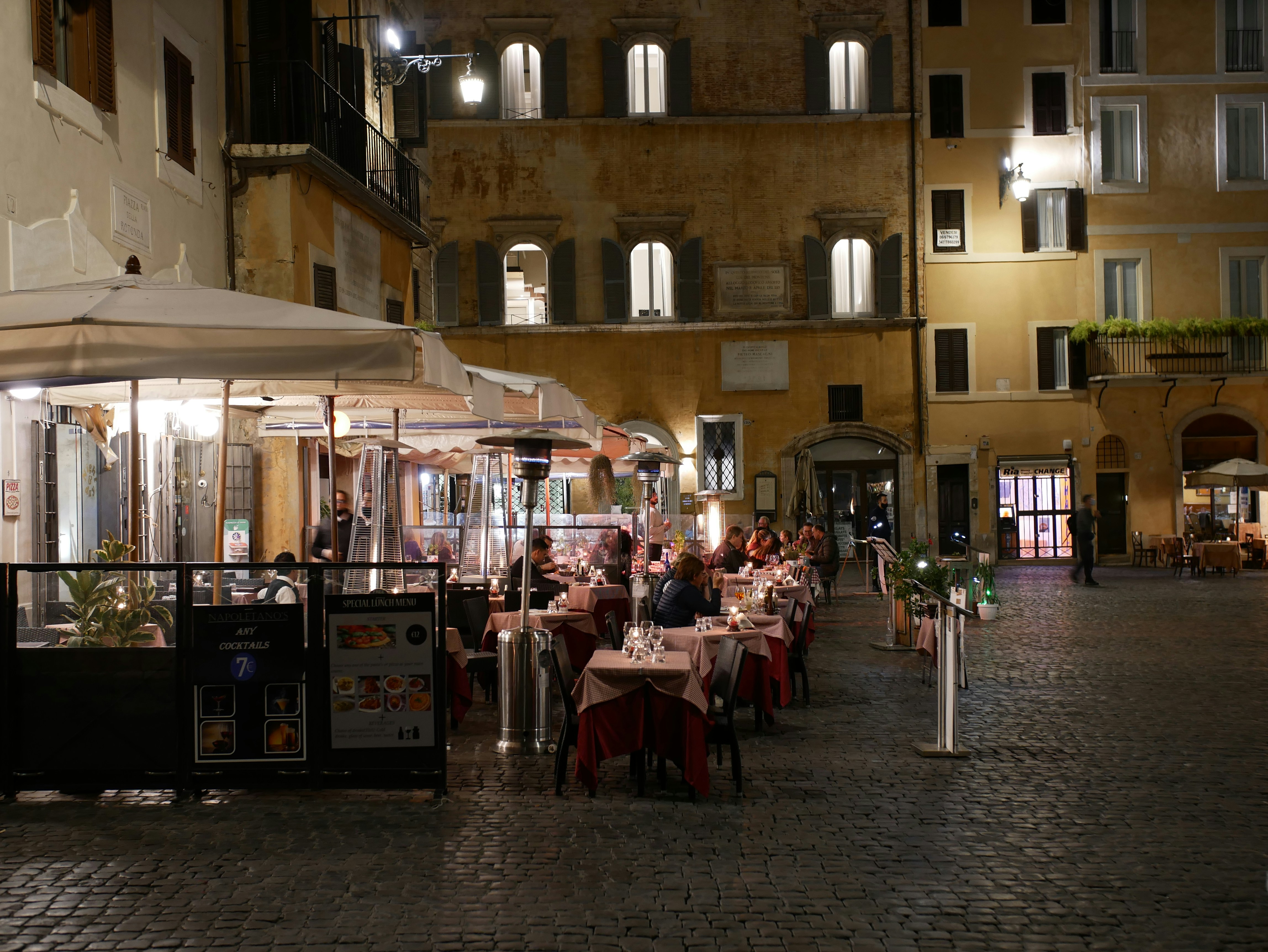 A nice terrace at night with people enjoying their Italian pasti in Rome.