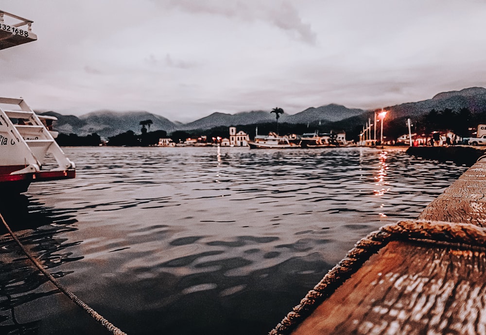 body of water near mountain during night time