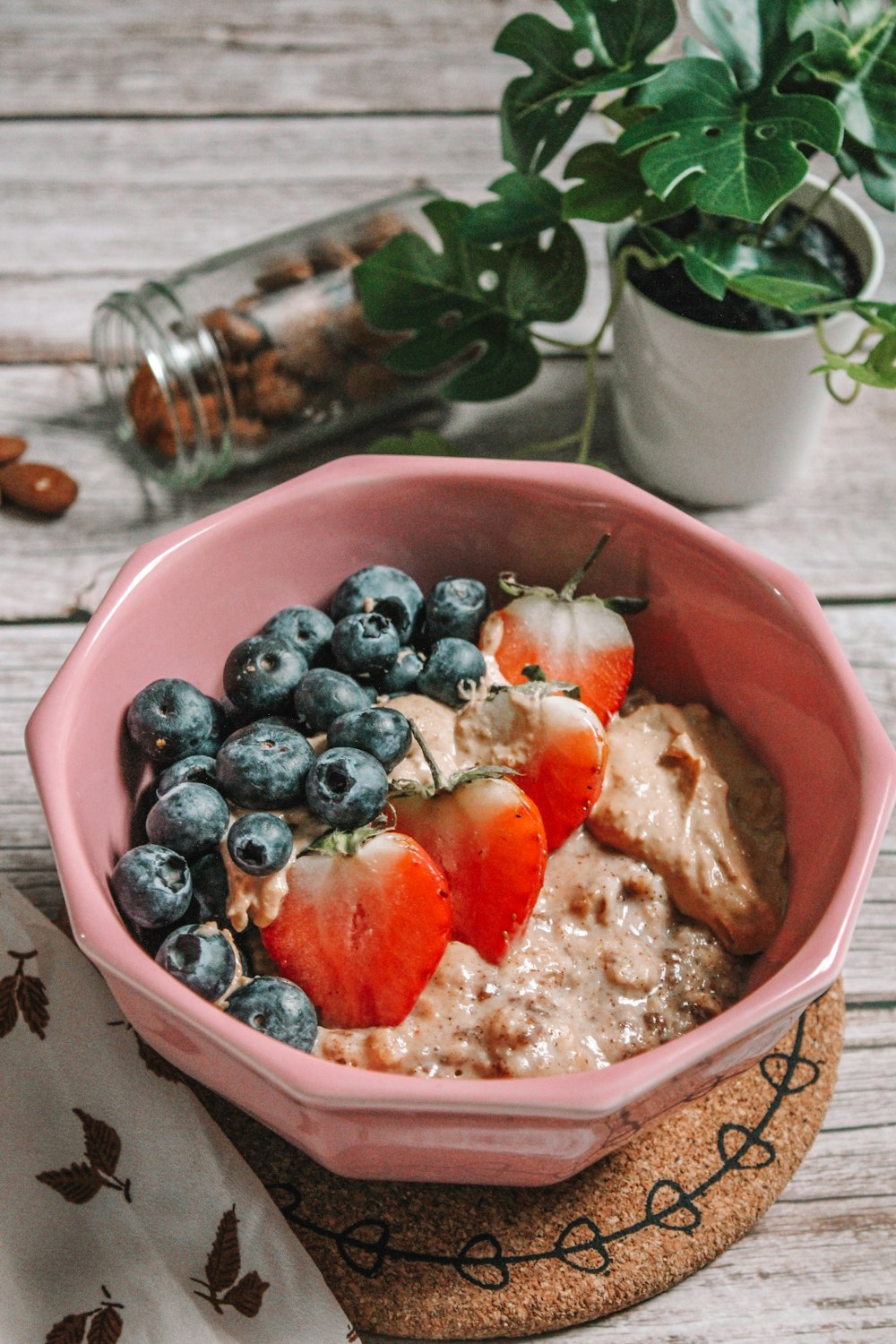 a bowl of oatmeal with strawberries and blueberries