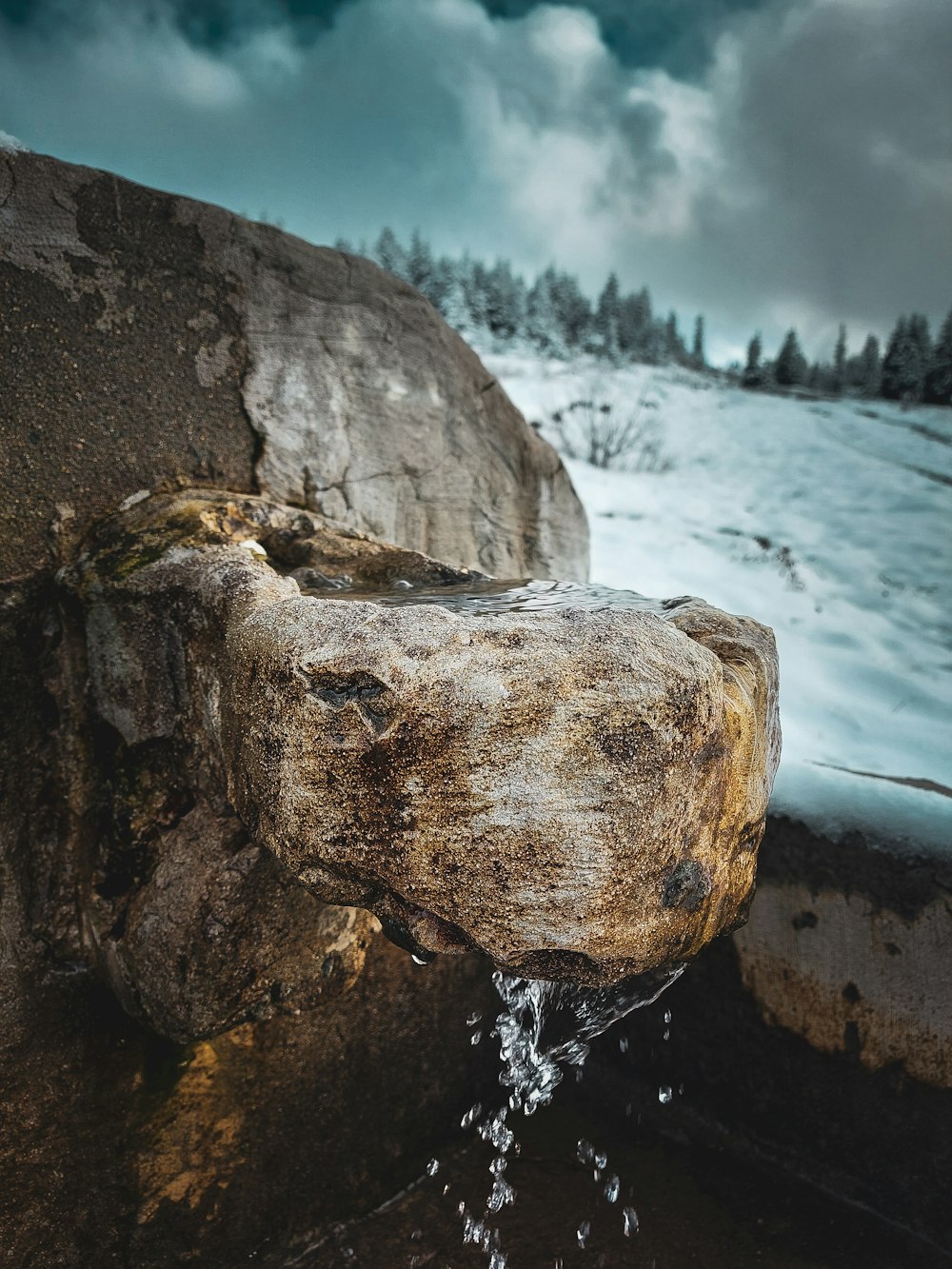 brown rock formation on water