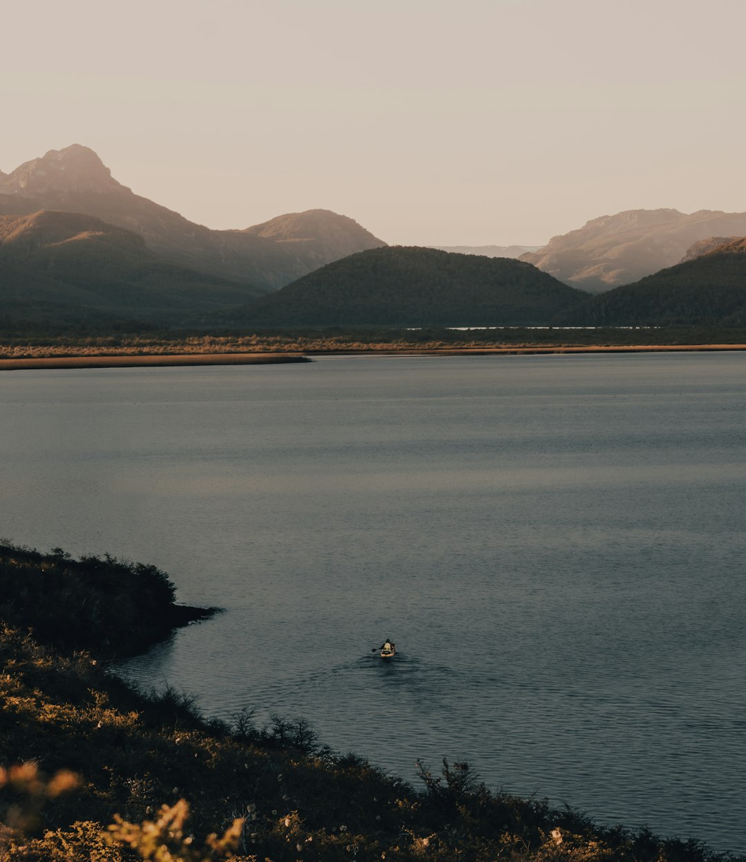 person riding on boat on lake during daytime