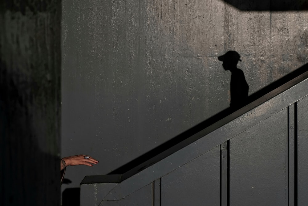 person in black pants walking on gray concrete stairs