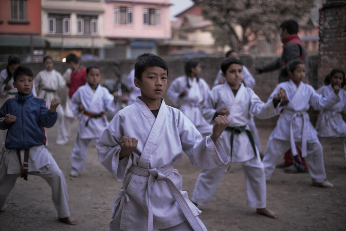 a group of kids in formation practising martial arts