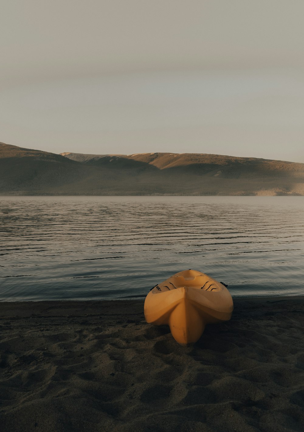 yellow kayak on sea shore during daytime