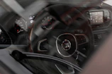 Original Fiat foot mats, both rubber winter and velour summer sets, neatly arranged inside a Fiat 500c.