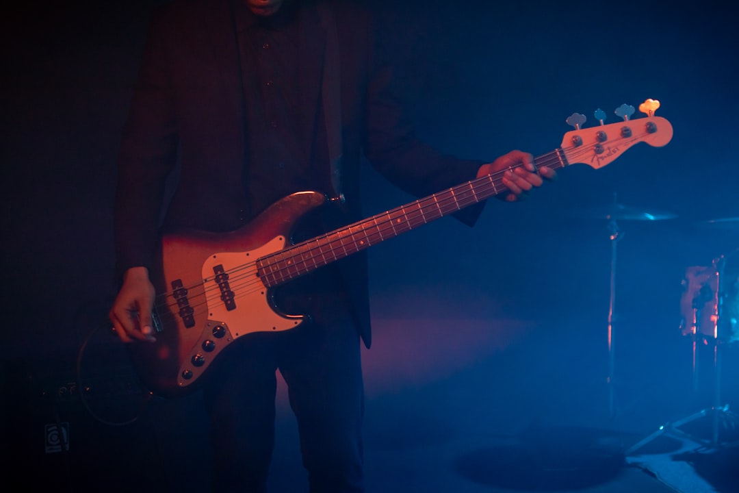 man playing electric guitar on stage