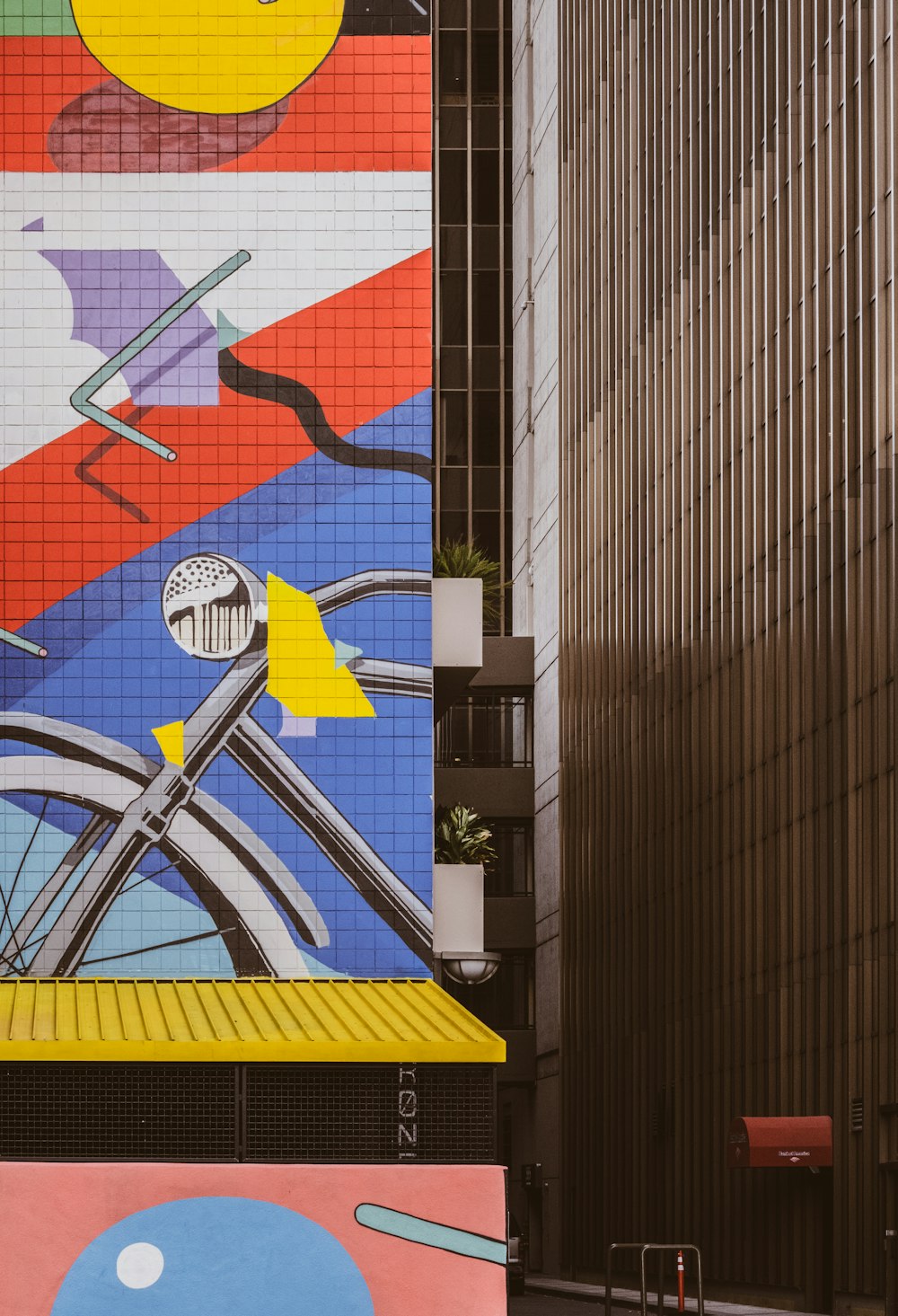 black bicycle parked beside black and white wall