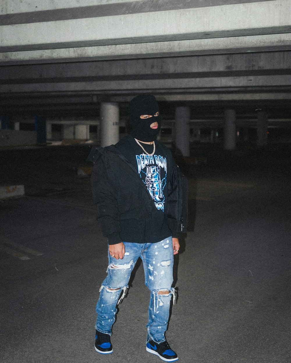 man in black hoodie and blue denim jeans standing on road during night time  photo – Free Grey Image on Unsplash
