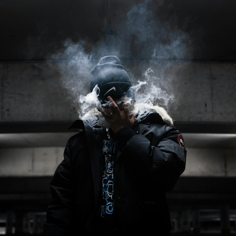 man in black jacket smoking