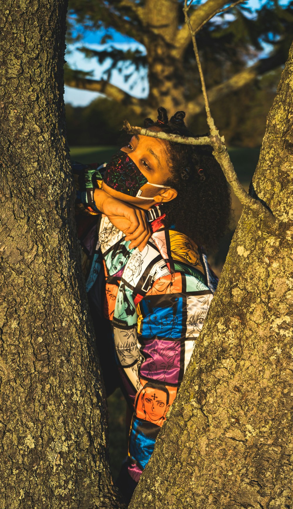 woman in blue and red dress lying on tree