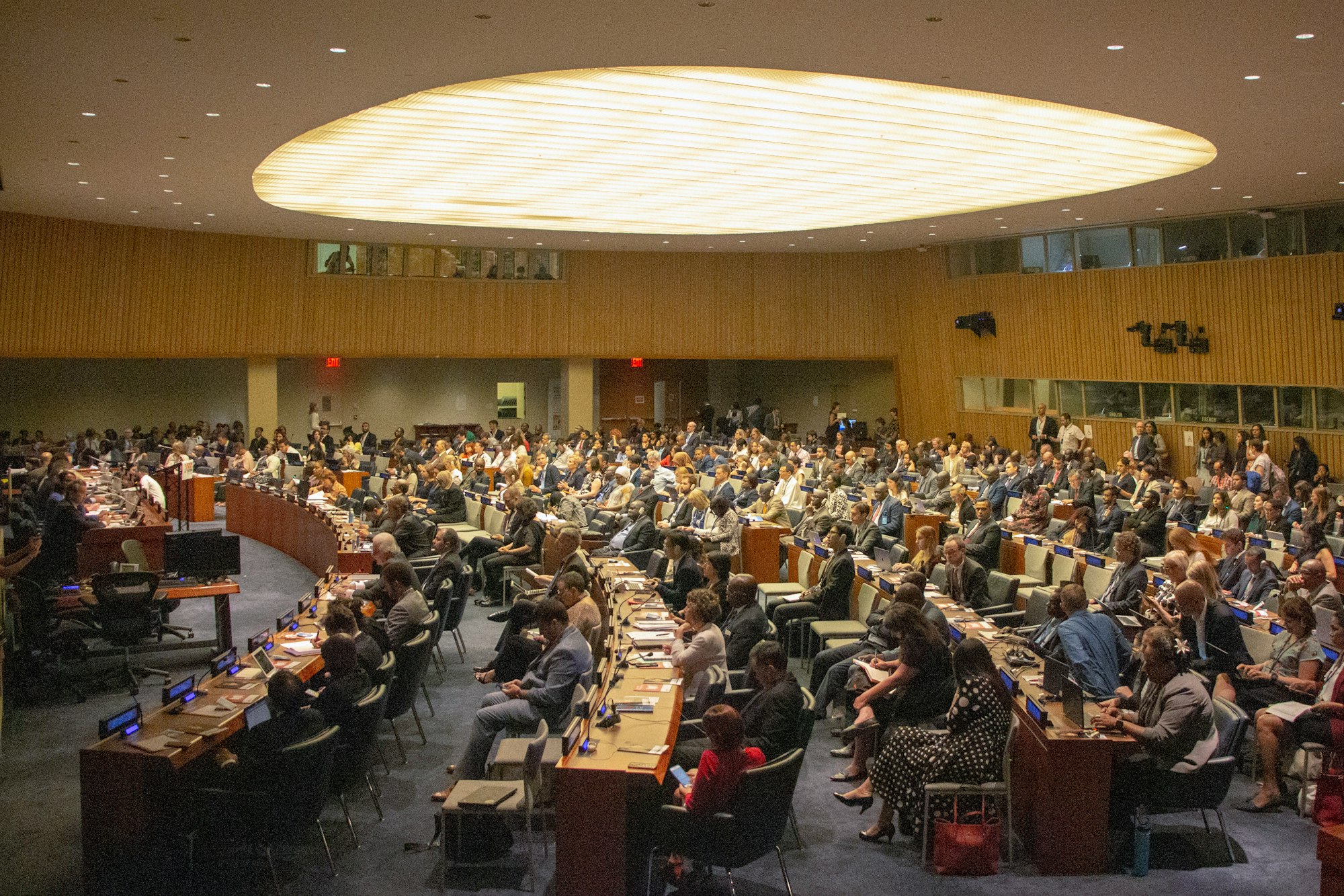 people sitting on chairs inside UN building