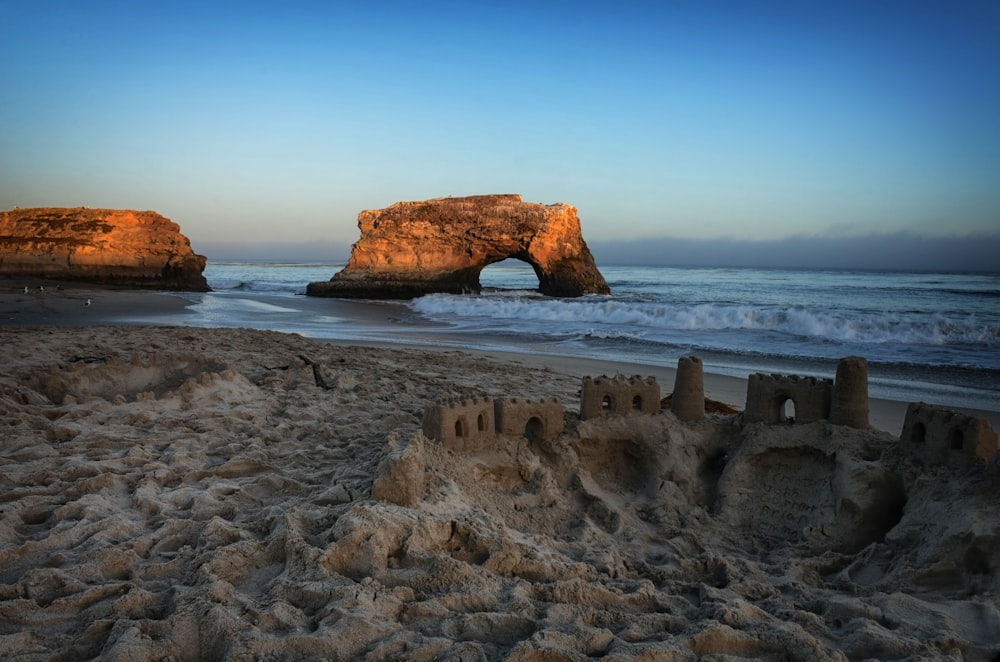 brown rock formation on sea during daytime