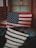 Close-up of a handcrafted wooden rustic American flag hanging on a cozy living room wall.