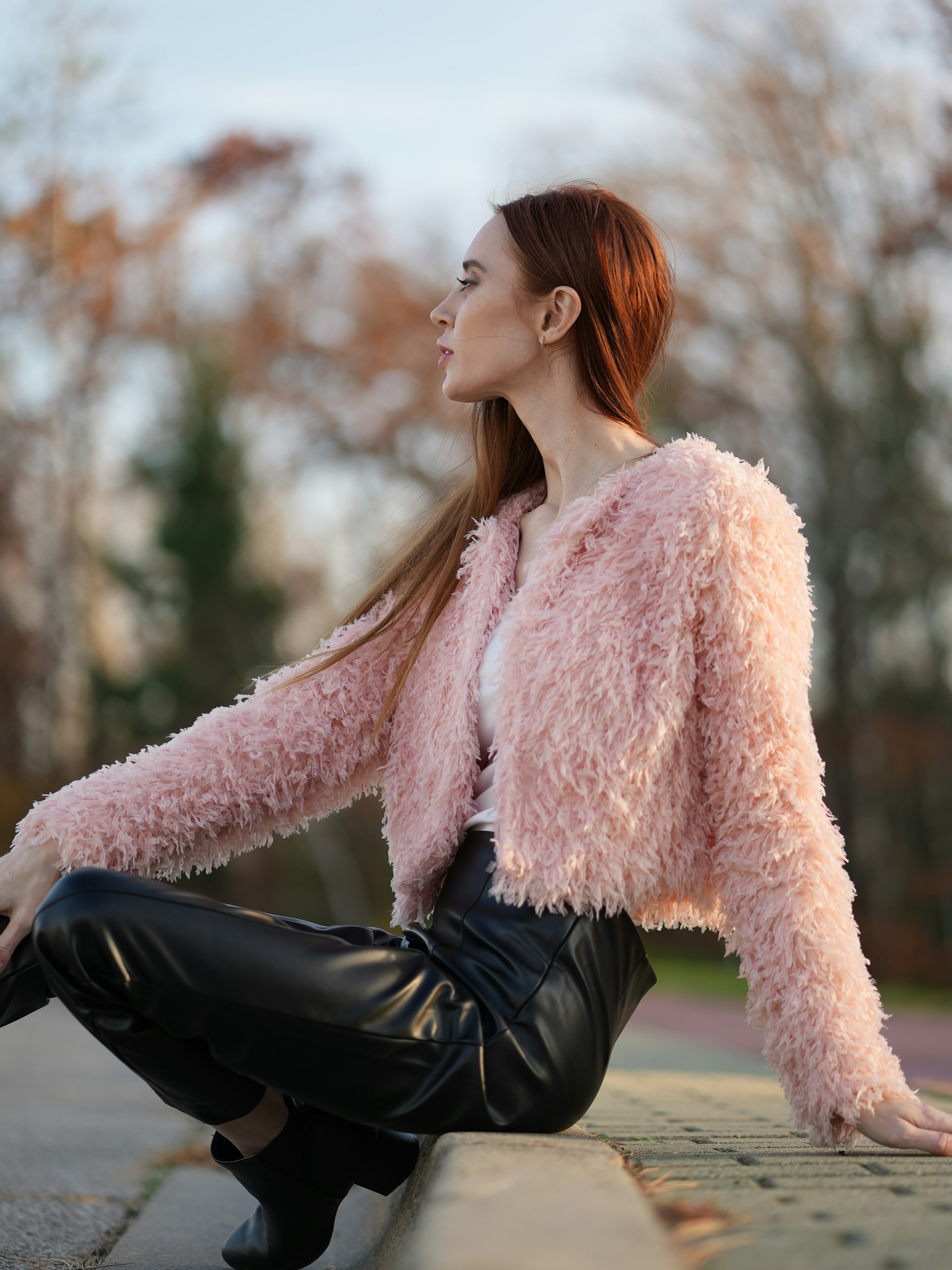 woman in pink fur coat and black pants