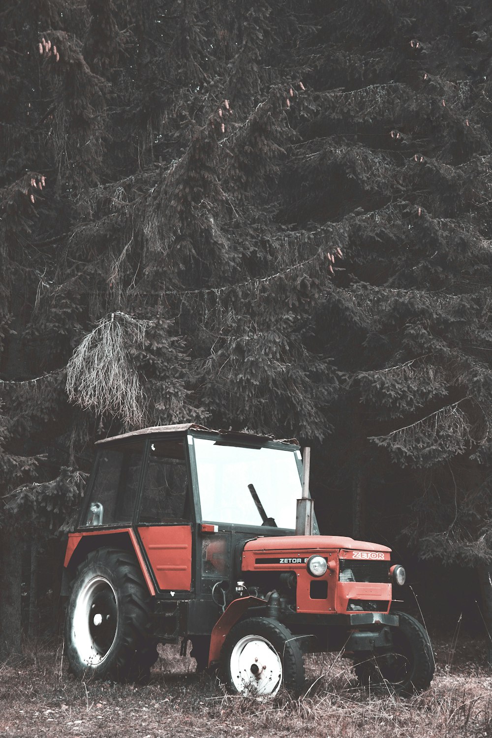 red and white tractor on snow covered ground