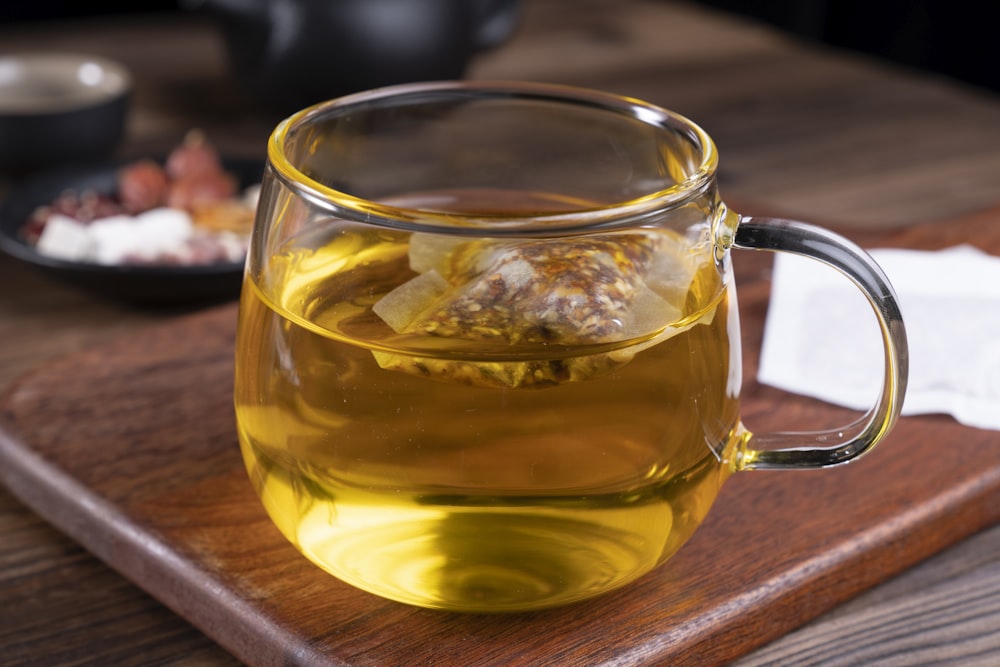 clear glass mug with yellow liquid