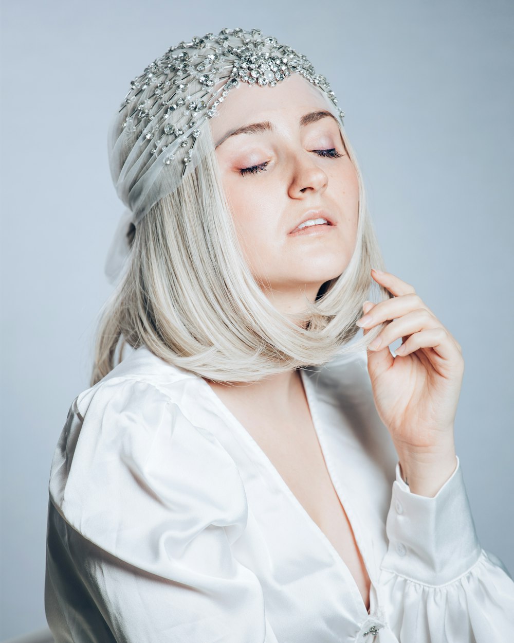 woman in white dress shirt wearing silver tiara