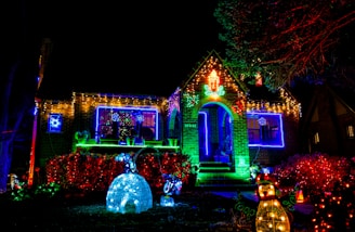 white and brown concrete building with green trees during night time