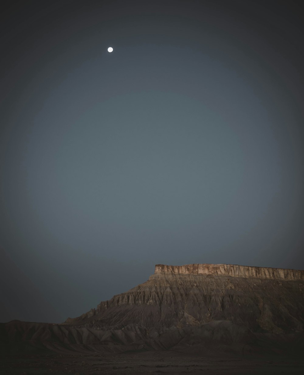 brown rocky mountain under white sky