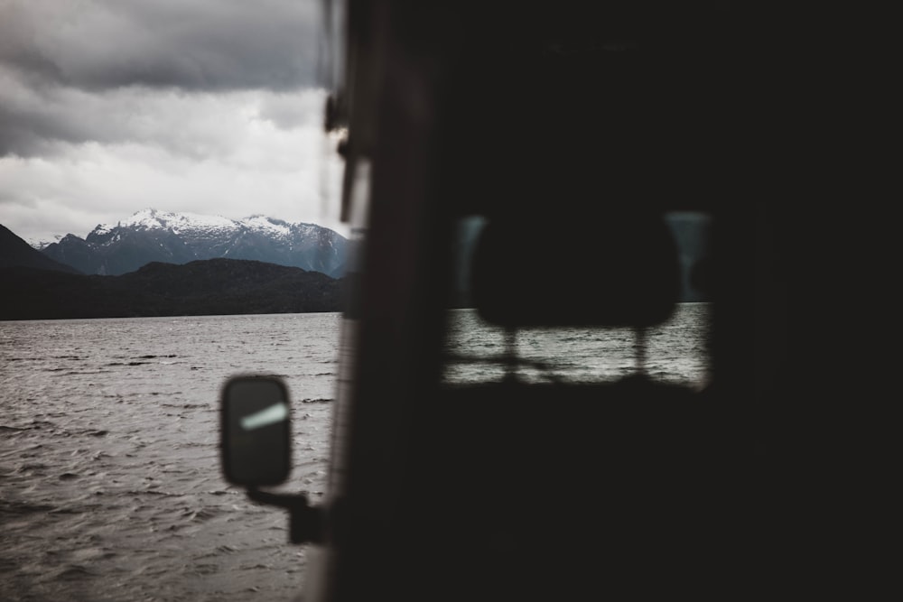 body of water near mountain during daytime