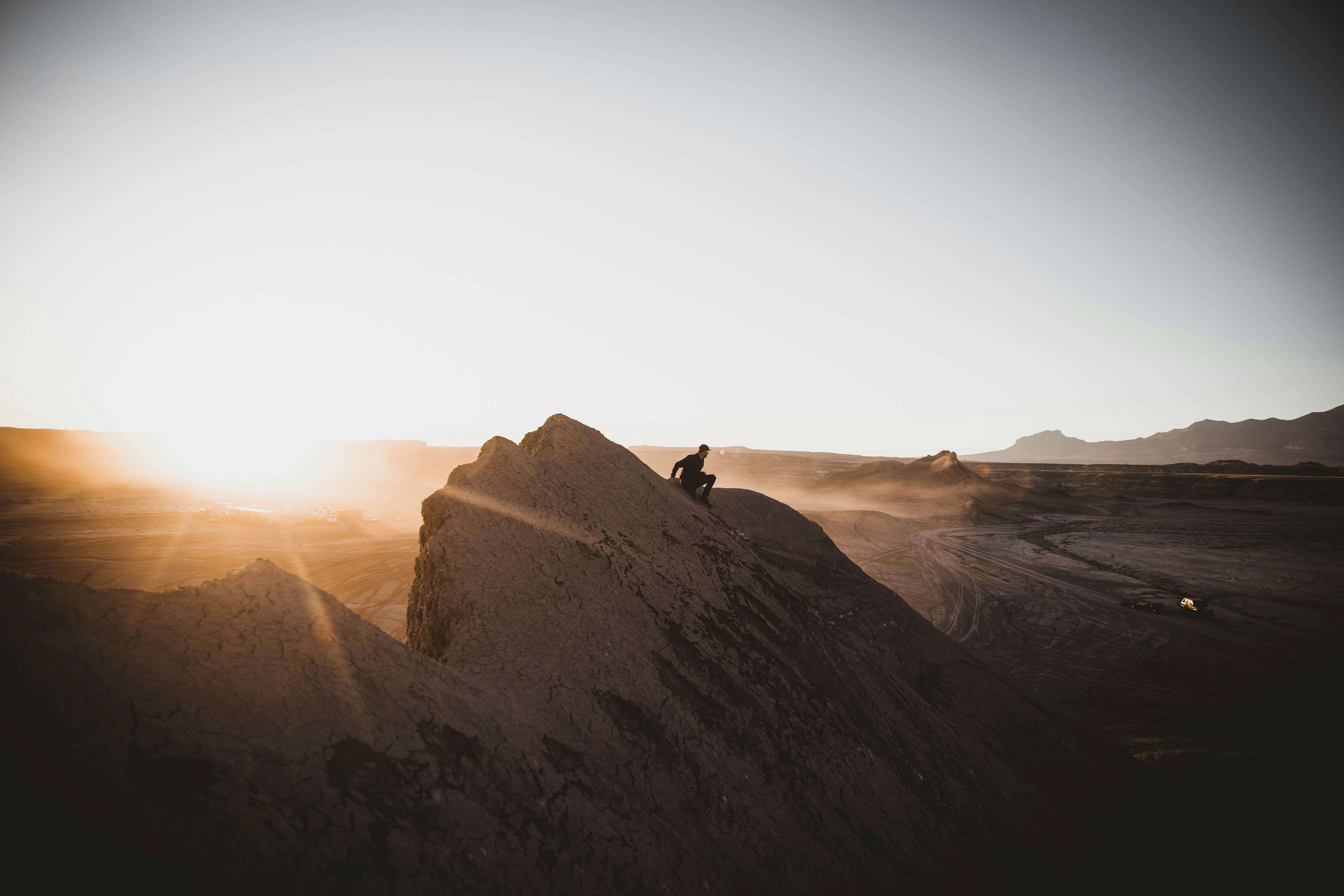 person standing on brown rock formation during daytime, 
