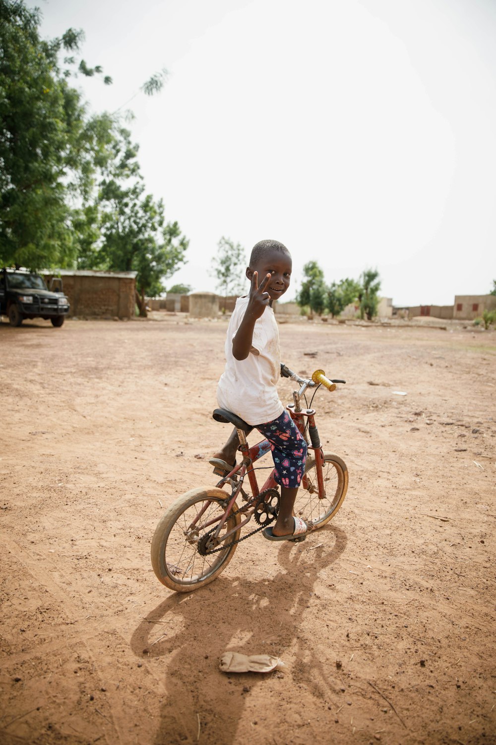 girl in white shirt riding on bicycle during daytime