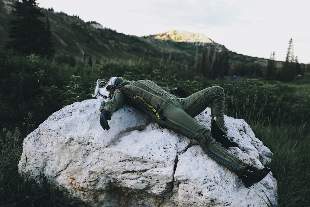 green and black robot on gray rock