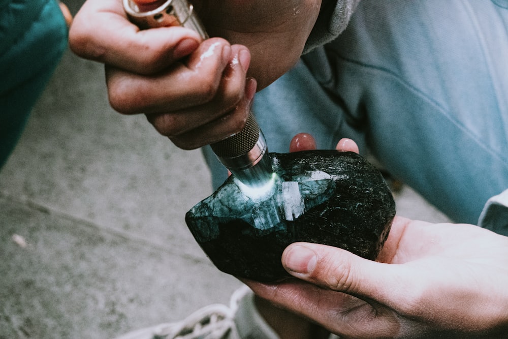 person holding black nail polish