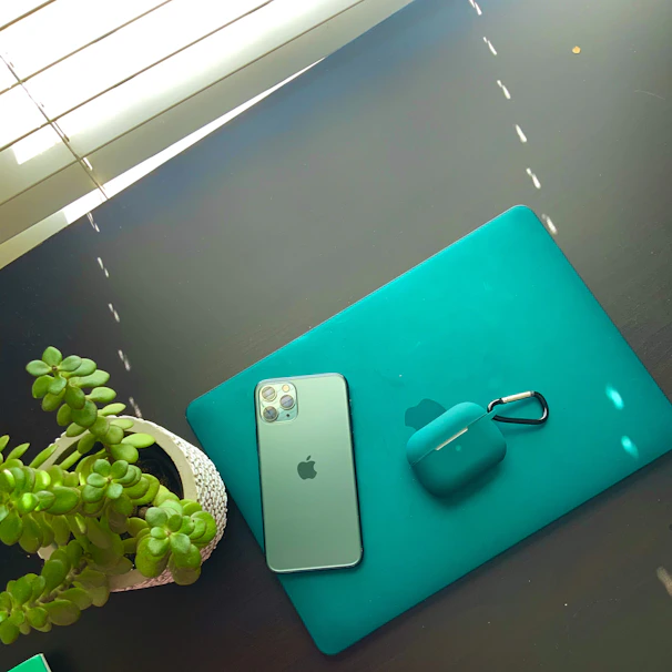 Professional cleaner carefully sanitizing a sleek office desk with teal accents