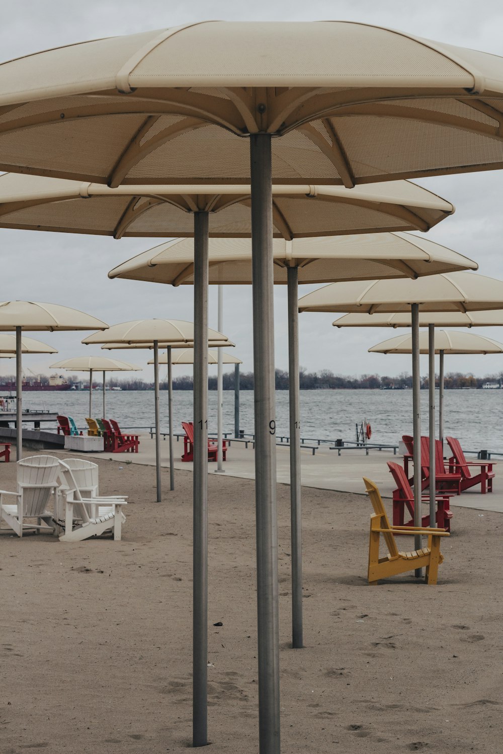 white and red outdoor chairs on beach during daytime