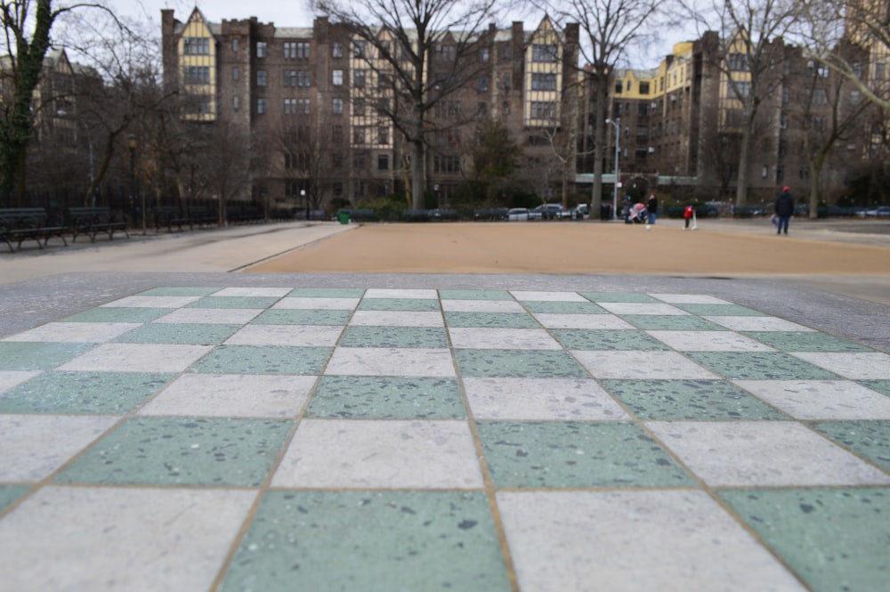 people walking on park near brown building during daytime