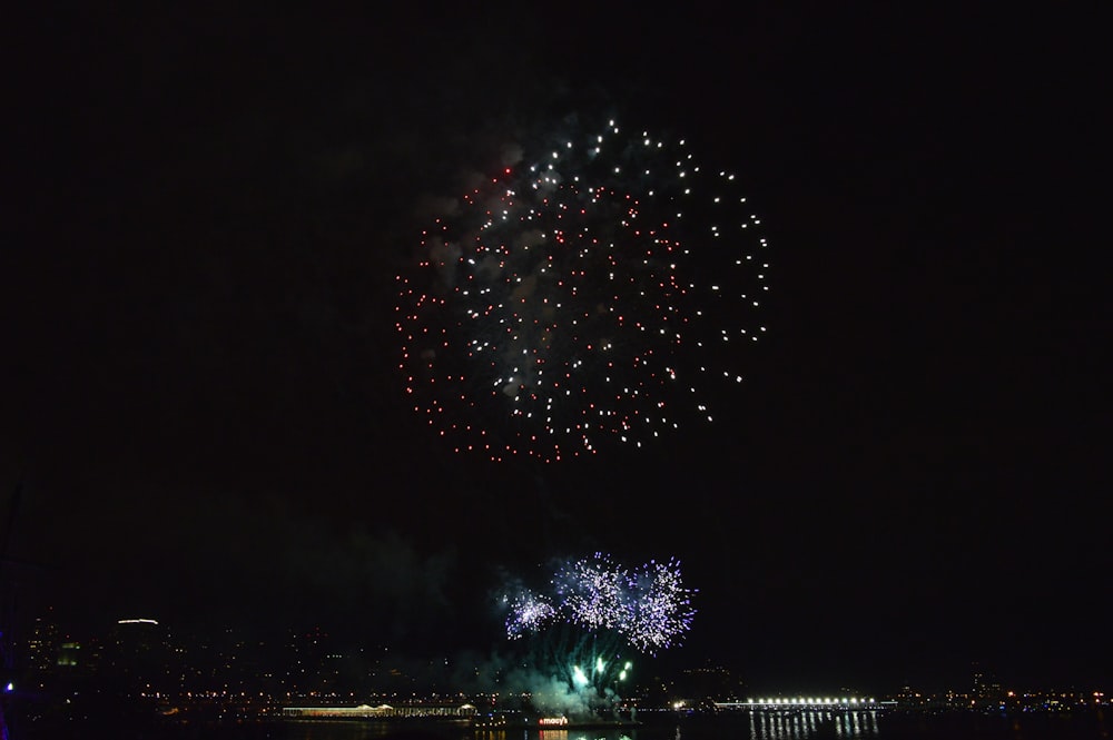 blue and white fireworks display during night time