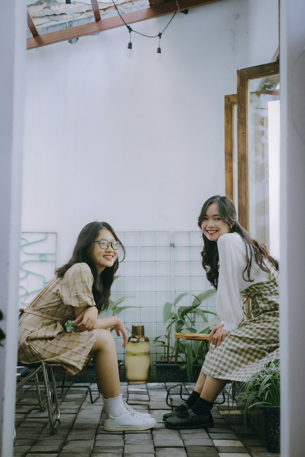 2 women sitting on chair