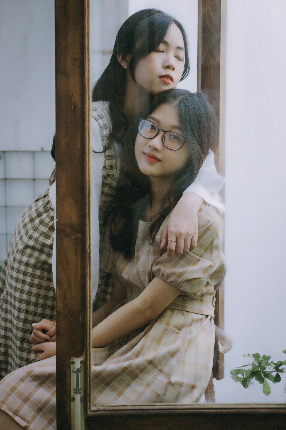 woman in black framed eyeglasses and brown button up shirt