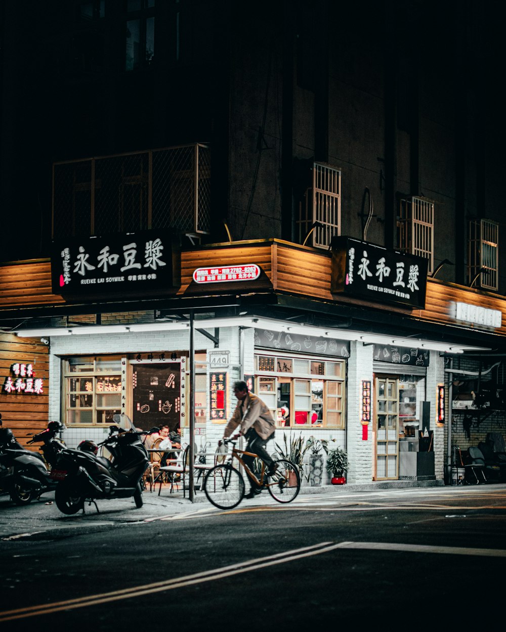 black motorcycle parked beside black motorcycle during night time