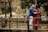 man in blue jacket standing beside woman in red dress