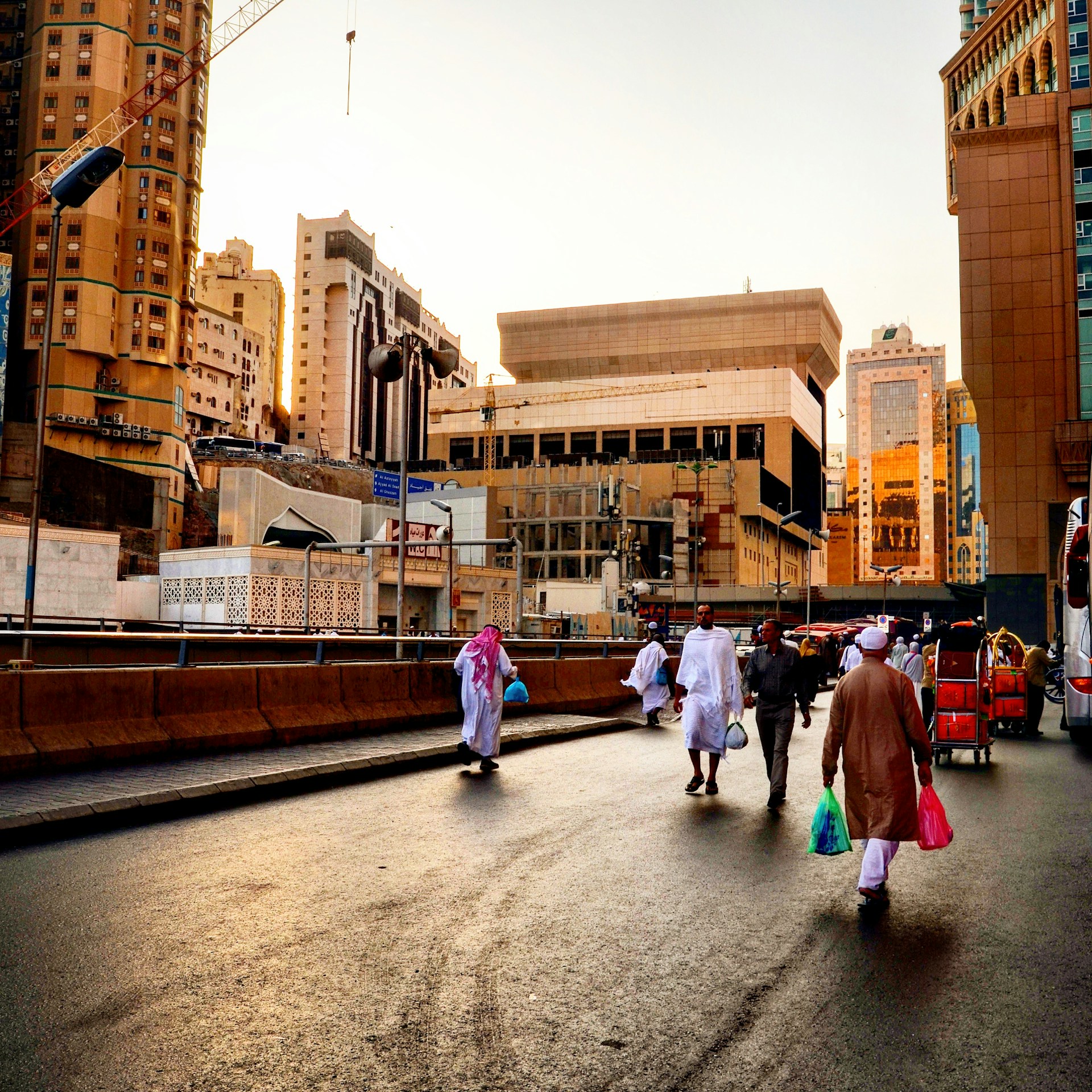 people walking on sidewalk near brown concrete building during daytime