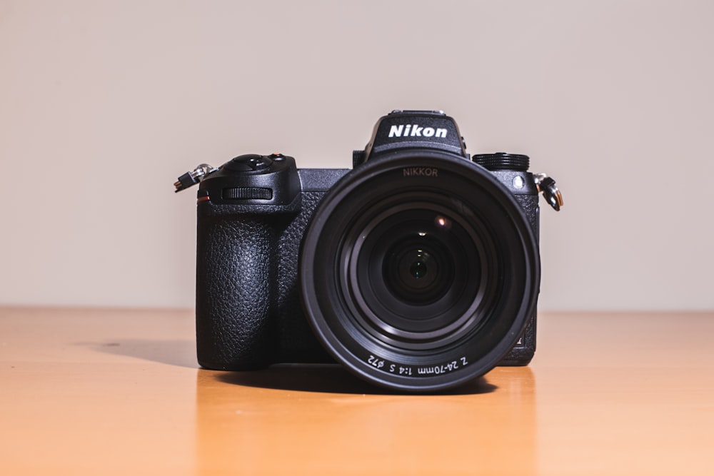 black nikon dslr camera on brown wooden table