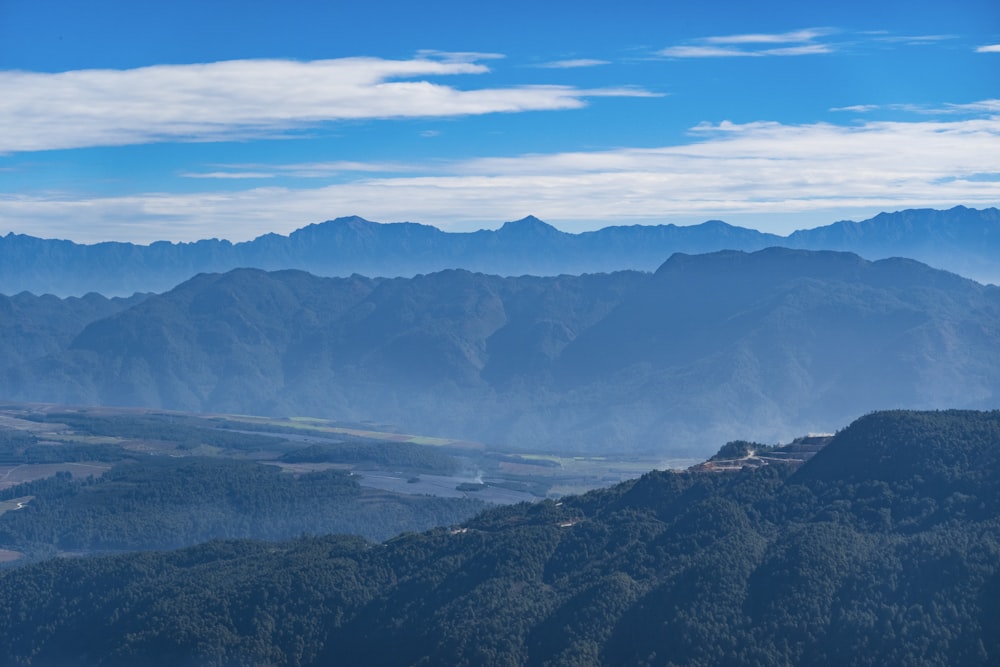 aerial view of mountains under blue sky during daytime