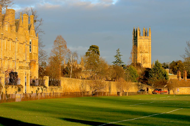 Historic stone facade of Marmion Lodge bathed in warm afternoon light, with Tamworth Castle visible in the background.