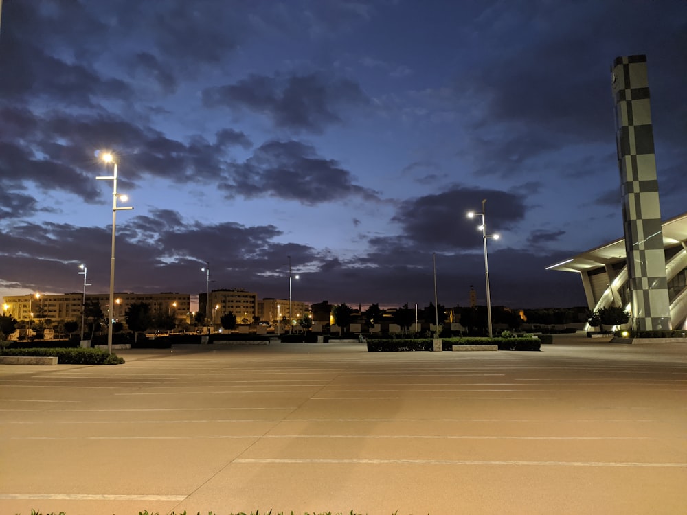 people walking on sidewalk during night time