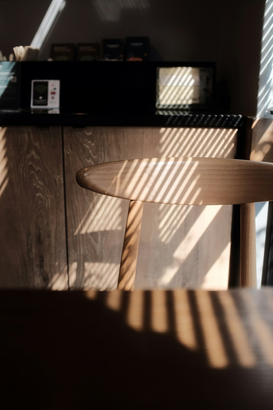 brown wooden chair beside brown wooden cabinet