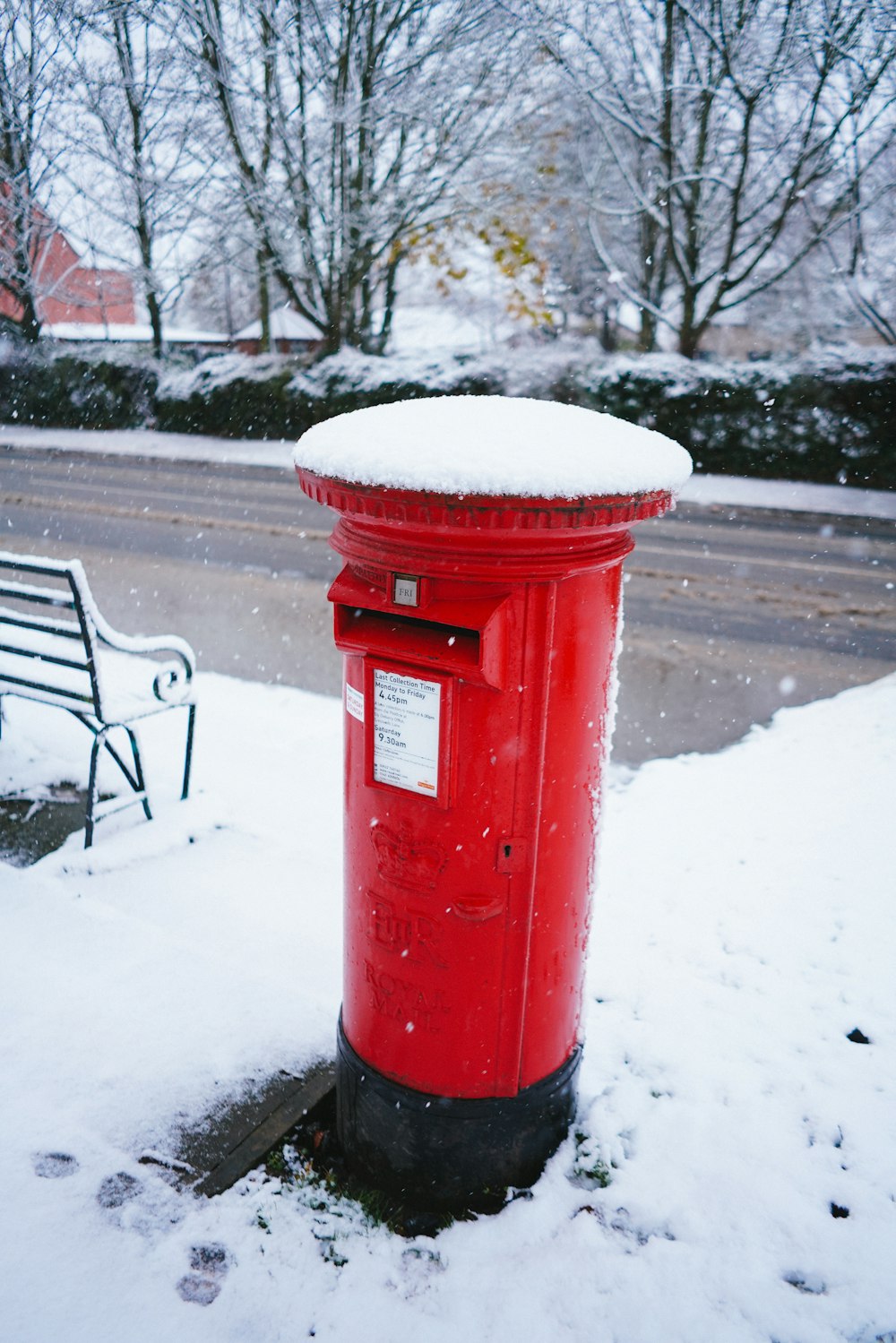 red mail box on snow covered ground