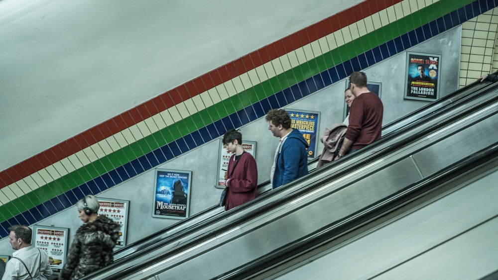 man in red shirt standing beside woman in gray long sleeve shirt