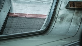 Close-up of a sleek escalator handrail with the Kalkar Enterprise logo visible.